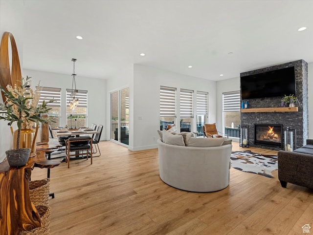 5796 N Valley View Rd, Lehi, UT 84043 - living area featuring light wood-style floors, a large fireplace, recessed lighting, and a chandelier