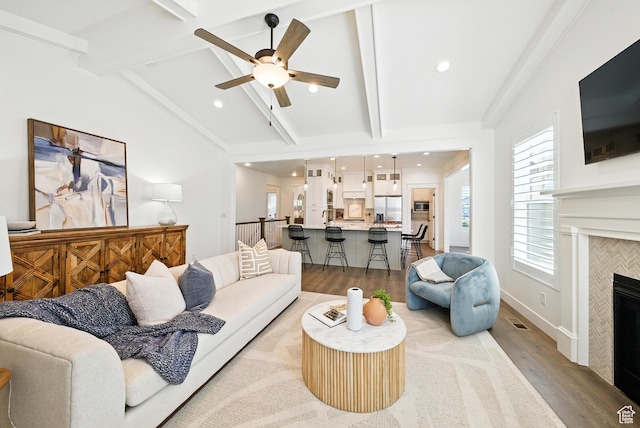 6331 W Copper Hawk Dr, South Jordan, UT 84009 - living room featuring light wood-style floors, ceiling fan, a tiled fireplace, and recessed lighting