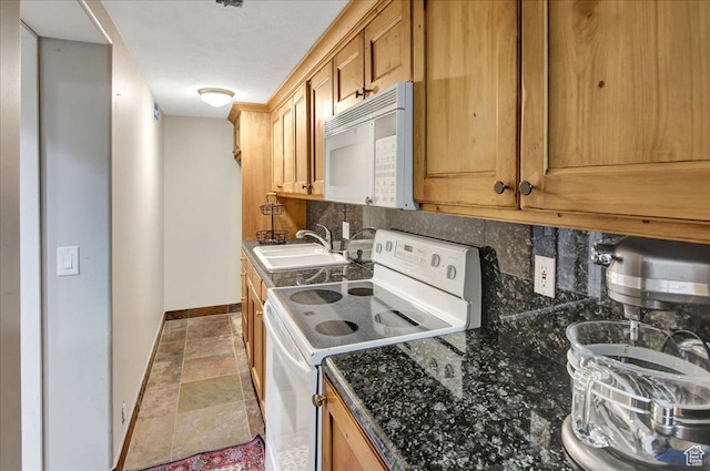 955 Mink Cir N, Salt Lake, UT 84054 - kitchen featuring white appliances, decorative backsplash, stone finish floors, and dark stone counters