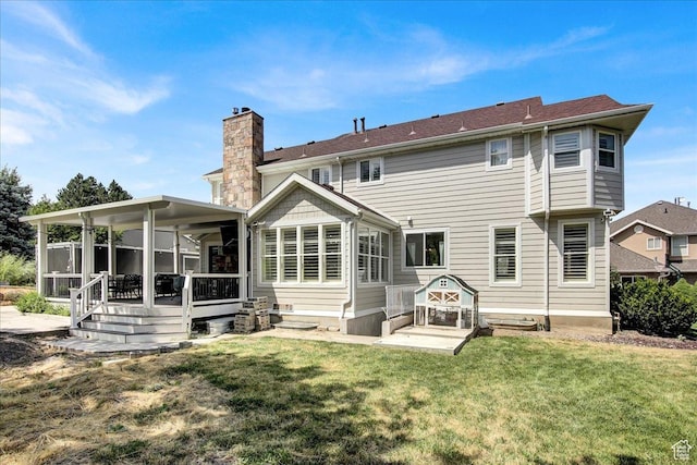 955 Mink Cir N, Salt Lake, UT 84054 - rear view of house featuring a chimney, a lawn, and a sunroom