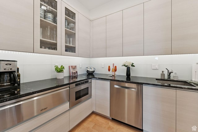 11515 N White Tail Ct, Hideout, UT 84036 - kitchen with appliances with stainless steel finishes, a warming drawer, decorative backsplash, dark stone countertops, and modern cabinets