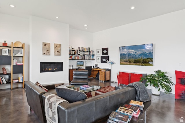 11515 N White Tail Ct, Hideout, UT 84036 - living area featuring finished concrete floors, a glass covered fireplace, a desk, and recessed lighting