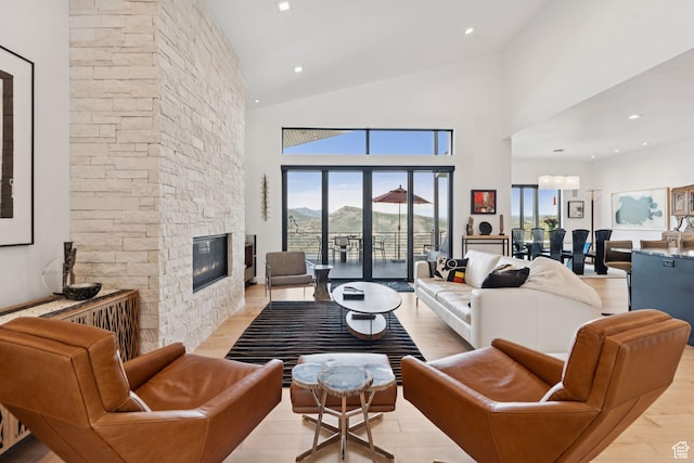 11515 N White Tail Ct, Hideout, UT 84036 - living room with a stone fireplace, high vaulted ceiling, and light wood-style floors