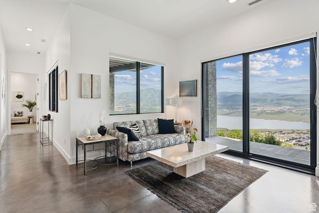 11515 N White Tail Ct, Hideout, UT 84036 - living area with concrete flooring, a water and mountain view, and recessed lighting