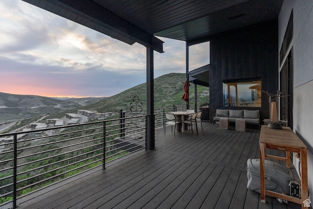 11515 N White Tail Ct, Hideout, UT 84036 - deck at dusk featuring a mountain view and an outdoor hangout area