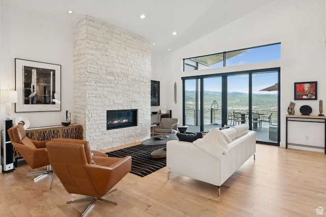11515 N White Tail Ct, Hideout, UT 84036 - living area featuring high vaulted ceiling, a stone fireplace, light wood finished floors, and recessed lighting