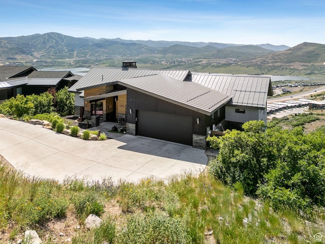11515 N White Tail Ct, Hideout, UT 84036 - contemporary home with a standing seam roof, an attached garage, driveway, a mountain view, and a metal roof