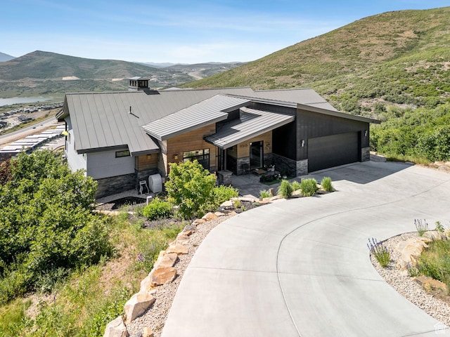11515 N White Tail Ct, Hideout, UT 84036 - view of front facade featuring stone siding, a standing seam roof, and a mountain view