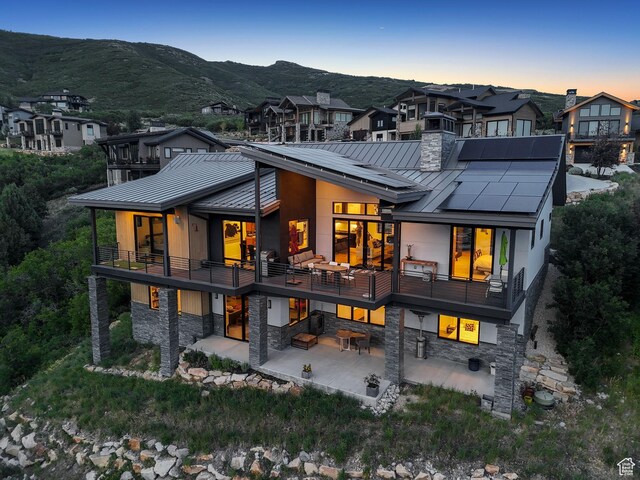 11515 N White Tail Ct, Hideout, UT 84036 - back of property with a standing seam roof, a metal roof, and a patio