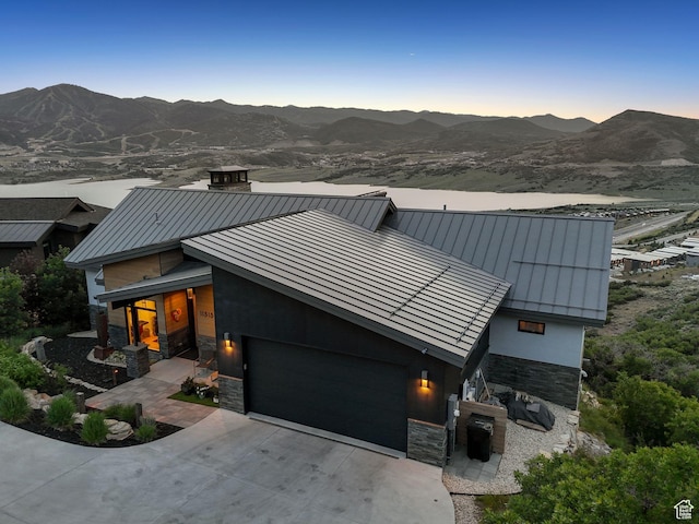11515 N White Tail Ct, Hideout, UT 84036 - contemporary home featuring a standing seam roof, stone siding, an attached garage, and a mountain view