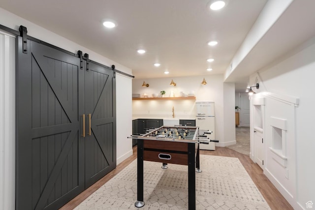 2071 S 500 E, Heber City, UT 84032 - recreation room with a barn door, light wood-style flooring, and recessed lighting