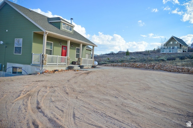 2070 S Sweetwater Parkway Park E Unit 33, Garden City, UT 84028 - view of front facade with a porch and roof with shingles