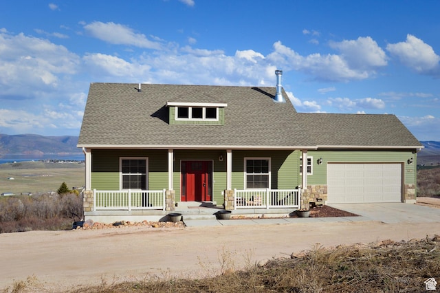 2070 S Sweetwater Parkway Park E Unit 33, Garden City, UT 84028 - view of front of property featuring covered porch, an attached garage, concrete driveway, and a shingled roof