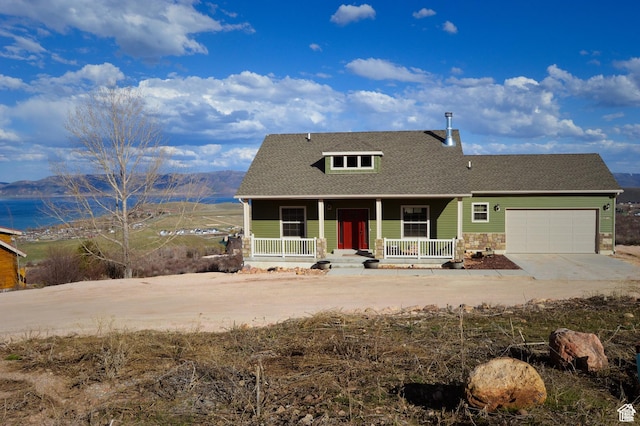 2070 S Sweetwater Parkway Park E Unit 33, Garden City, UT 84028 - view of front of home with a porch, a garage, roof with shingles, driveway, and stone siding