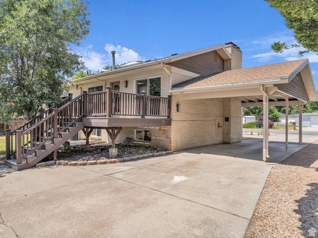 1432 E Colony Dr, Holladay, UT 84117 - rear view of property featuring driveway, stairs, brick siding, a deck, and a shingled roof