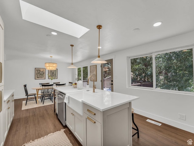 1432 E Colony Dr, Holladay, UT 84117 - kitchen with a skylight, white cabinets, light countertops, dark wood finished floors, and recessed lighting