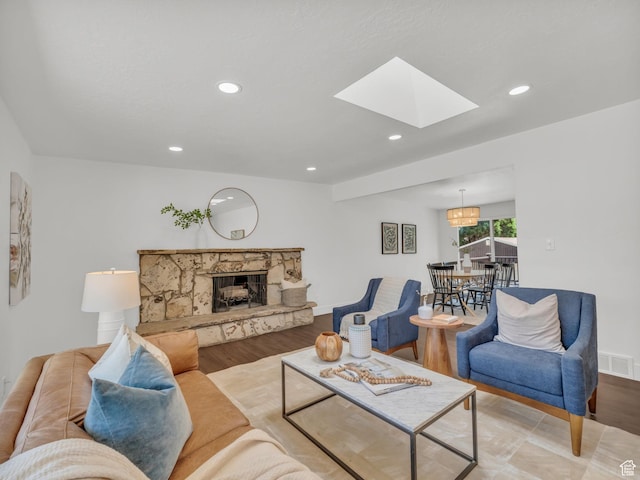 1432 E Colony Dr, Holladay, UT 84117 - living room featuring a skylight, wood finished floors, recessed lighting, and a stone fireplace