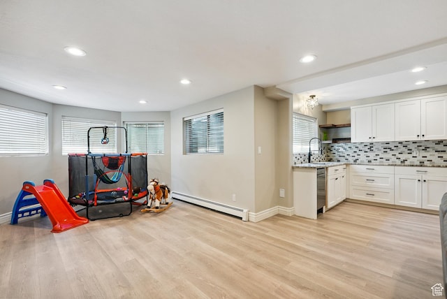 12671 S Somerdowns Ct, Draper, UT 84020 - rec room with a baseboard heating unit, light wood finished floors, and recessed lighting