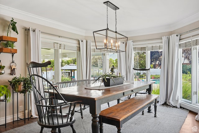 12671 S Somerdowns Ct, Draper, UT 84020 - dining room featuring ornamental molding, a chandelier, healthy amount of natural light, and wood finished floors