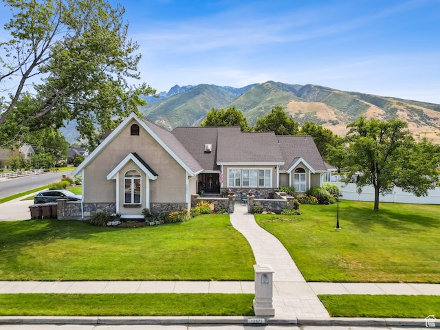 12671 S Somerdowns Ct, Draper, UT 84020 - view of front of property featuring stone siding, a front lawn, a mountain view, and stucco siding
