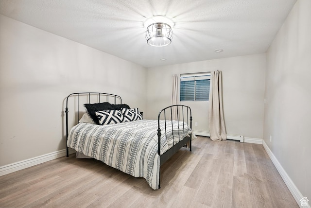 12671 S Somerdowns Ct, Draper, UT 84020 - bedroom featuring light wood finished floors and a baseboard radiator
