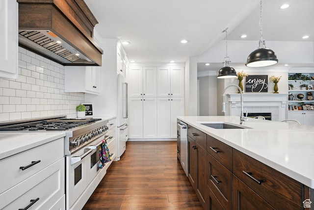 12671 S Somerdowns Ct, Draper, UT 84020 - kitchen with double oven range, premium range hood, dark brown cabinets, white cabinetry, and light countertops
