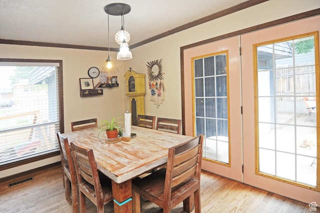 136 E 700 S, Farmington, UT 84025 - dining room with light wood-style floors, plenty of natural light, and ornamental molding