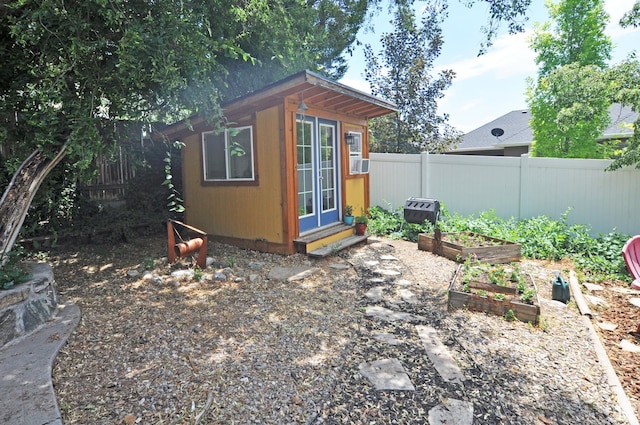136 E 700 S, Farmington, UT 84025 - view of outdoor structure featuring a fenced backyard, a garden, and cooling unit