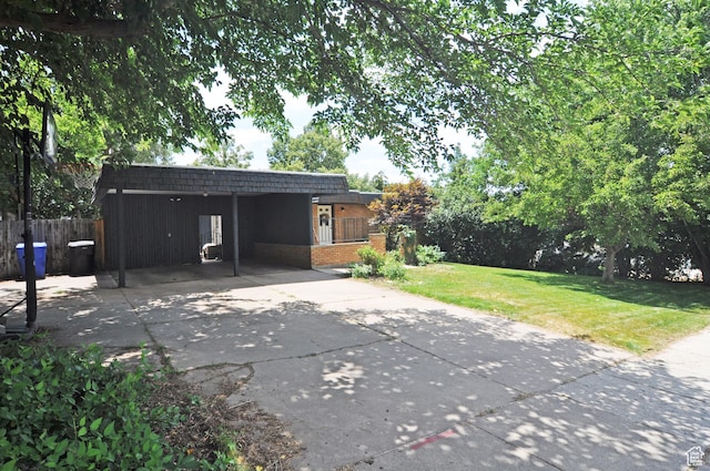 136 E 700 S, Farmington, UT 84025 - view of front facade featuring mansard roof, brick siding, a carport, and concrete driveway