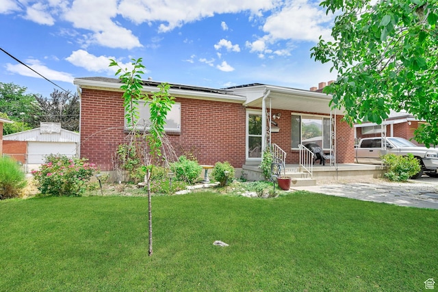 3347 S Rulon St W, Magna, UT 84044 - view of front of property with a front lawn, a porch, and brick siding