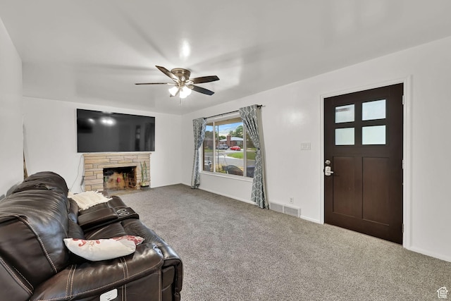 3347 S Rulon St W, Magna, UT 84044 - living area with carpet, a ceiling fan, and a stone fireplace