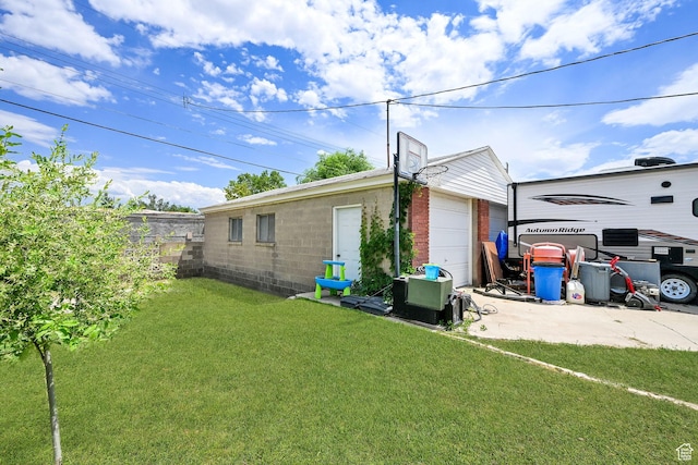 3347 S Rulon St W, Magna, UT 84044 - view of side of property featuring a lawn, an outdoor structure, and a garage