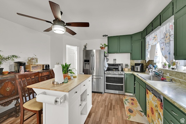 3347 S Rulon St W, Magna, UT 84044 - kitchen with green cabinets, stainless steel appliances, light wood-type flooring, a ceiling fan, and butcher block countertops