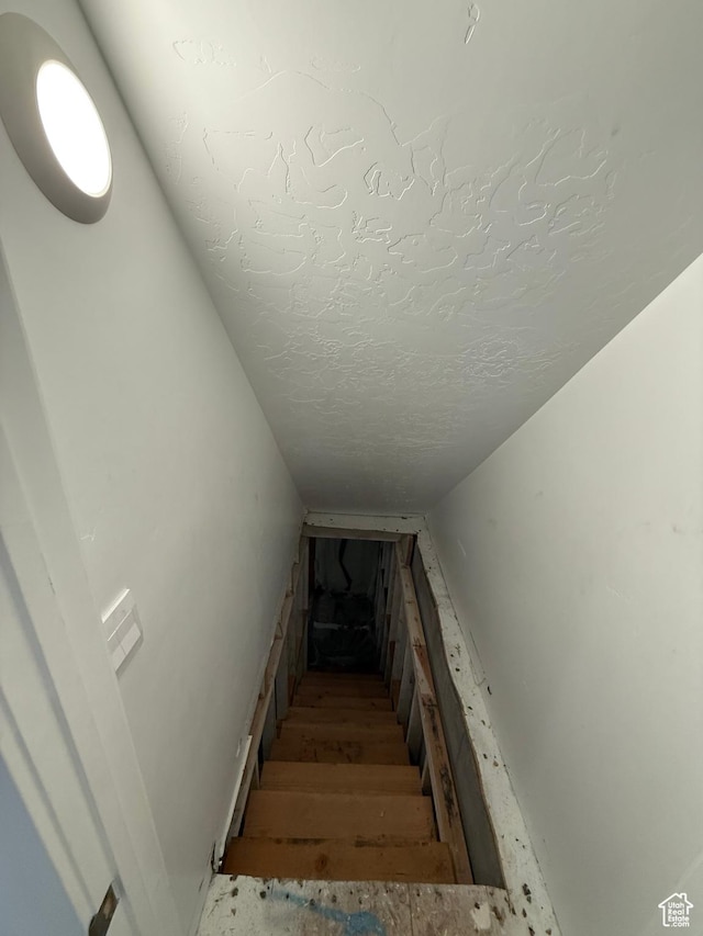 1144 E Trident Dr S, Saratoga Springs, UT 84045 - staircase featuring a textured ceiling