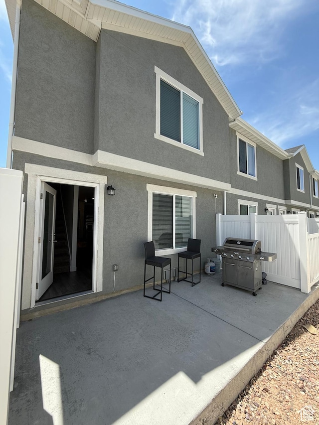 1144 E Trident Dr S, Saratoga Springs, UT 84045 - rear view of property with stucco siding and a patio area