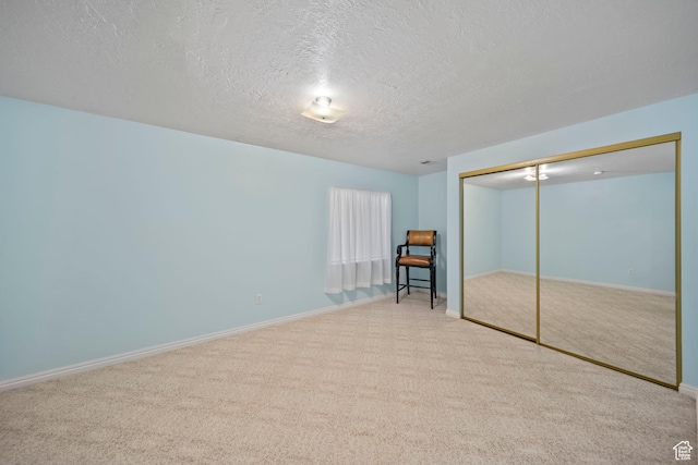 5149 W Village Wood Dr, West Valley City, UT 84120 - unfurnished bedroom with carpet flooring, a textured ceiling, and a closet