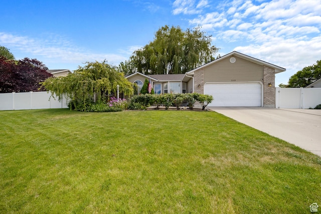5149 W Village Wood Dr, West Valley City, UT 84120 - view of front of property with driveway, a garage, and brick siding