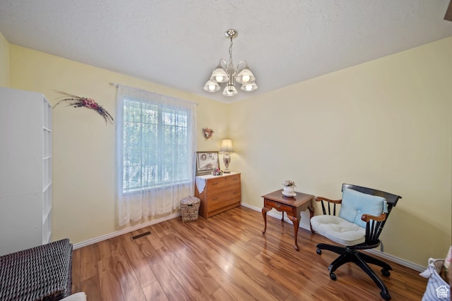 5149 W Village Wood Dr, West Valley City, UT 84120 - sitting room featuring a chandelier and light wood-style flooring