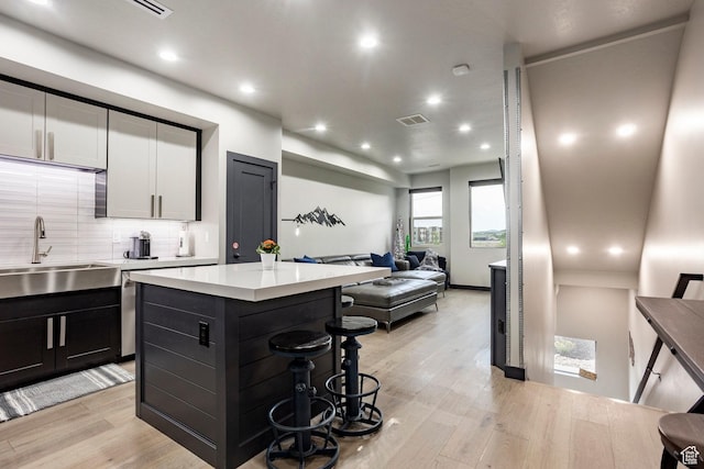 6627 Mountain Alder Way, Park City, UT 84098 - kitchen featuring open floor plan, decorative backsplash, light wood finished floors, light countertops, and recessed lighting