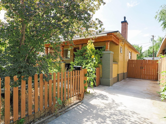 320 E Hollywood Ave S, Salt Lake City, UT 84115 - view of side of property with a gate and a chimney