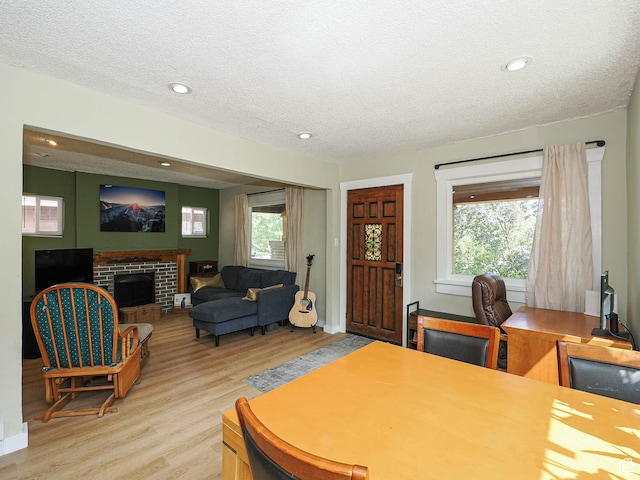 320 E Hollywood Ave S, Salt Lake City, UT 84115 - dining space featuring light wood-style flooring, a textured ceiling, healthy amount of natural light, a fireplace, and recessed lighting