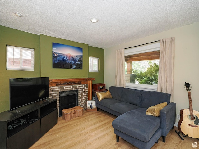 320 E Hollywood Ave S, Salt Lake City, UT 84115 - living room featuring a textured ceiling, wood finished floors, and a fireplace