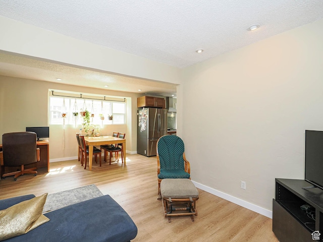 320 E Hollywood Ave S, Salt Lake City, UT 84115 - living area with light wood-style floors and a textured ceiling