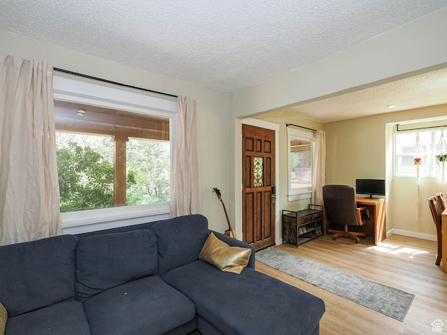 320 E Hollywood Ave S, Salt Lake City, UT 84115 - living area featuring a textured ceiling, light wood-style flooring, and an office area
