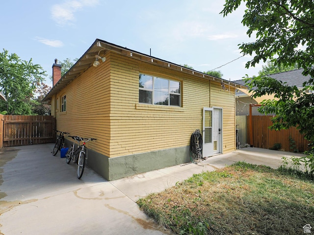 320 E Hollywood Ave S, Salt Lake City, UT 84115 - view of side of property featuring a patio area and a chimney