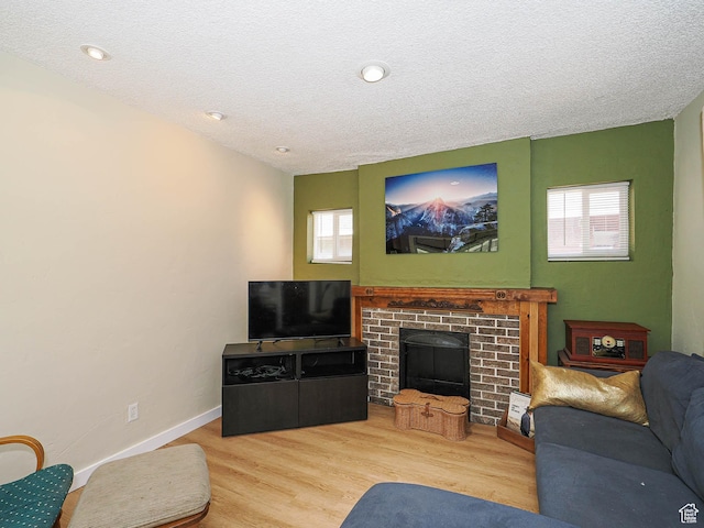320 E Hollywood Ave S, Salt Lake City, UT 84115 - living area featuring healthy amount of natural light, wood finished floors, a textured ceiling, and a fireplace