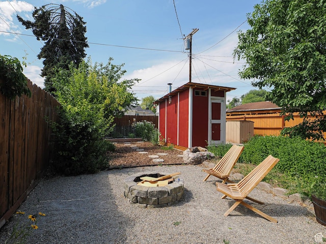 320 E Hollywood Ave S, Salt Lake City, UT 84115 - fenced backyard featuring a storage unit and an outdoor fire pit