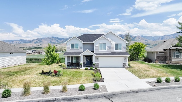 659 S Lakeside Dr, Franklin, ID 83237 - view of front of house featuring concrete driveway, covered porch, a mountain view, a garage, and a front lawn
