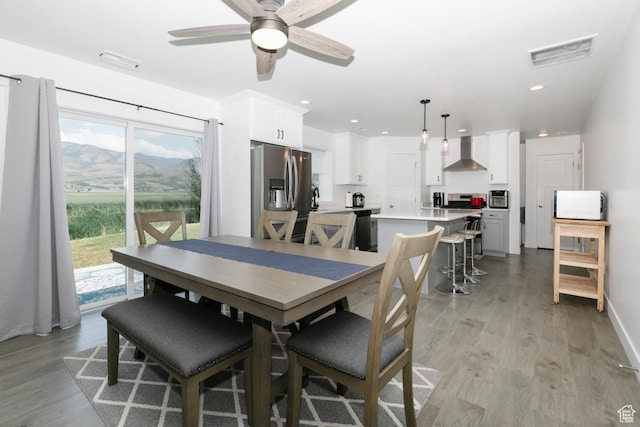 659 S Lakeside Dr, Franklin, ID 83237 - dining room with light wood finished floors, ceiling fan, and recessed lighting