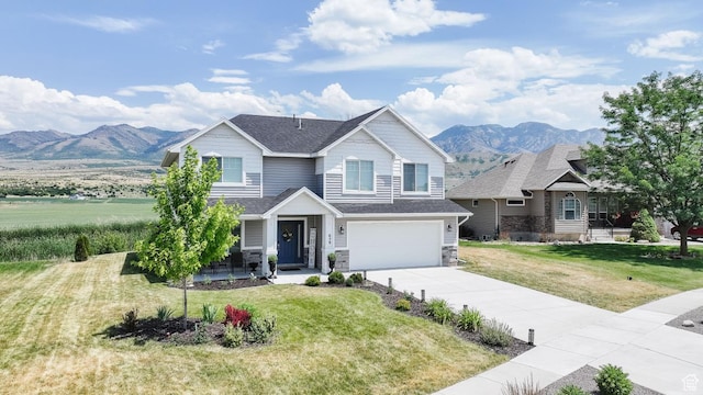 659 S Lakeside Dr, Franklin, ID 83237 - view of front of home featuring a mountain view, driveway, an attached garage, and a front lawn